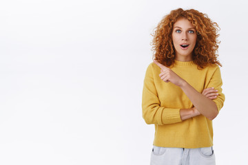 Surprised, excited and enthusiastic redhead curly woman asking question about amazing event promo,...