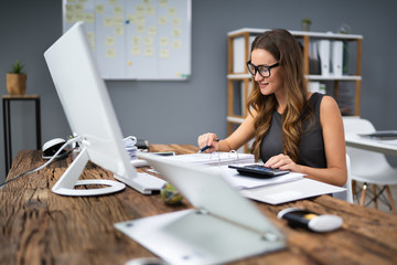 Smiling Businesswoman Calculating Tax