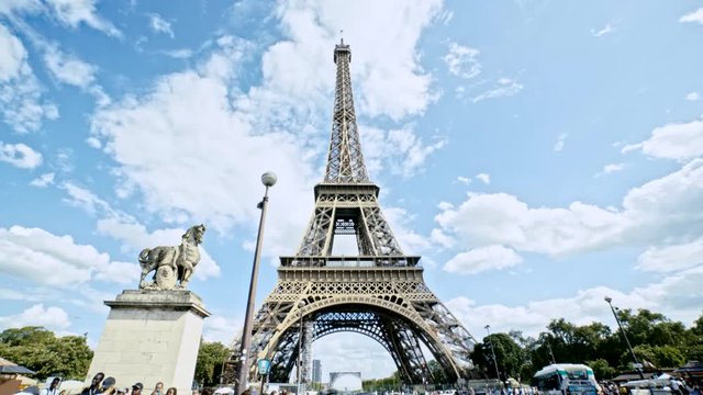 Approaching to Iconic Landmark of Paris France. Eiffel Tower, Tourist Crowd and Traffic Under Summer Sunlight and Beautiful Sky