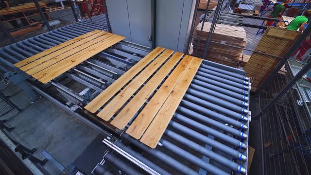 Automated equipment of a parquet factory. Industrial process of furniture production. Interior of modern robotic plant.
