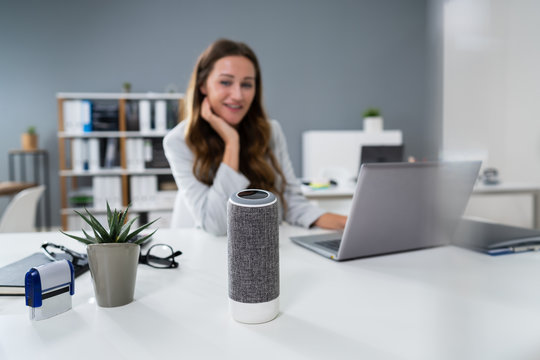 Woman Listening To Music On Wireless Speaker