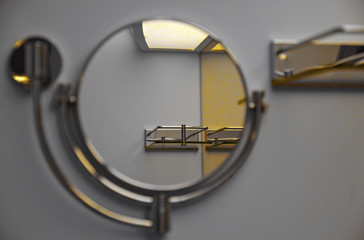 Close up and detail of swiveling mirror with reflection of light and shelf inside bathroom of cabin...