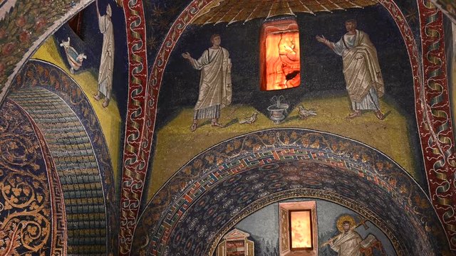Ravenna, Italy, December 2019. Mausoleum of Galla Placidia, tilt footage on a lunette with the apostles. The drinking doves represent the search for eternal peace at the source of divine salvation.