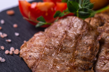  grilled meat and fried potatoes and fresh vegetables1