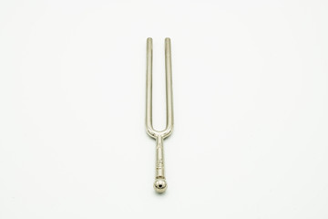 A tuning fork 440 Hz on a white background