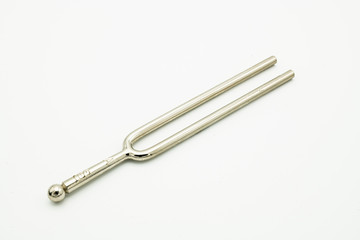 A tuning fork 440 Hz on a white background