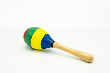 A colorful maracas lying on a white underground