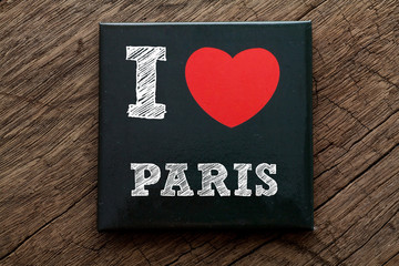 I Love My Paris written on black note with wood background