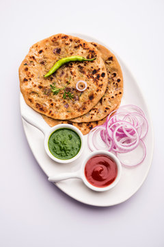 Onion Parotha / Pyaj parantha / kanda paratha served with tomato ketchup and green chutney. selective focus