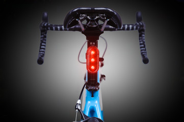 Close-up of bicycle saddle and illuminated tail light