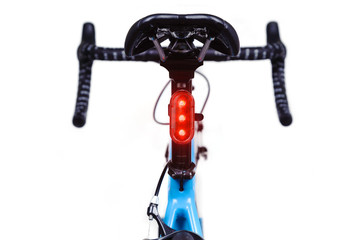 Close-up of bicycle saddle and illuminated tail light