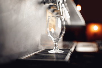 Beer taps cider wineglass raw in pub. Selective focus, dark background