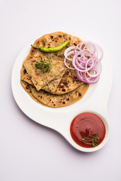 Onion Parotha / Pyaj parantha / kanda paratha served with tomato ketchup and green chutney. selective focus
