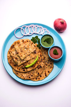 Onion Parotha / Pyaj parantha / kanda paratha served with tomato ketchup and green chutney. selective focus