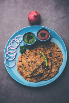 Onion Parotha / Pyaj parantha / kanda paratha served with tomato ketchup and green chutney. selective focus