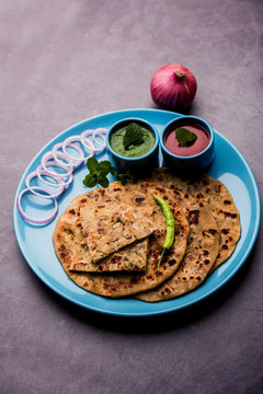 Onion Parotha / Pyaj parantha / kanda paratha served with tomato ketchup and green chutney. selective focus