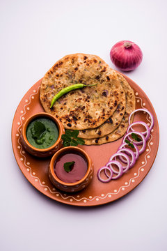Onion Parotha / Pyaj parantha / kanda paratha served with tomato ketchup and green chutney. selective focus