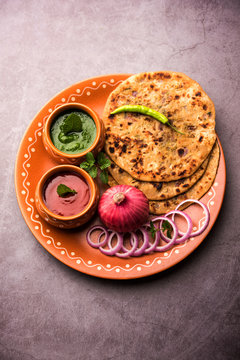 Onion Parotha / Pyaj parantha / kanda paratha served with tomato ketchup and green chutney. selective focus