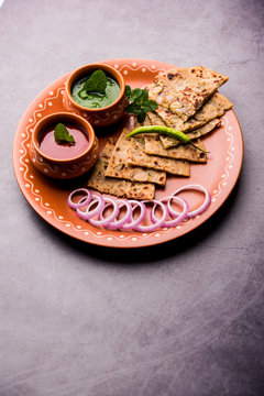 Onion Parotha / Pyaj parantha / kanda paratha served with tomato ketchup and green chutney. selective focus