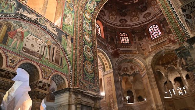 Ravenna, Italy, December 2019. Inside the basilica of San Vitale, footage with tilt movement on the large arch with the busts of the saints.
