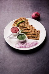 Onion Parotha / Pyaj parantha / kanda paratha served with tomato ketchup and green chutney. selective focus