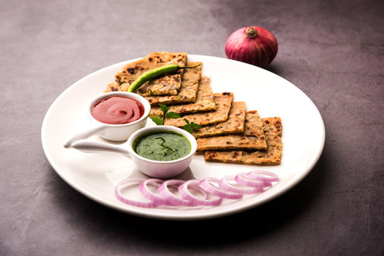 Onion Parotha / Pyaj parantha / kanda paratha served with tomato ketchup and green chutney. selective focus