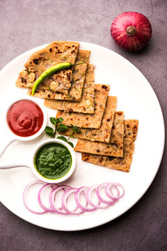 Onion Parotha / Pyaj parantha / kanda paratha served with tomato ketchup and green chutney. selective focus