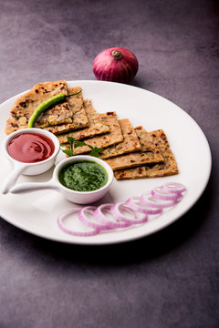 Onion Parotha / Pyaj parantha / kanda paratha served with tomato ketchup and green chutney. selective focus