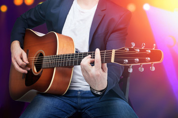 Obraz na płótnie Canvas Closeup of a guy playing an acoustic guitar.