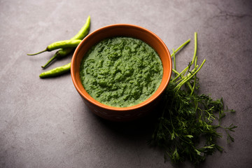 Kothimbir or Dhaniya Chutney made using Cilantro or coriander with chilli, served in a bowl. selective focus