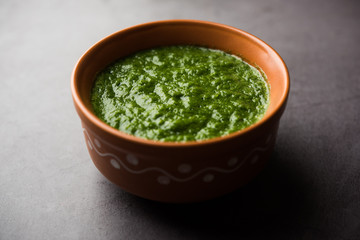 Kothimbir or Dhaniya Chutney made using Cilantro or coriander with chilli, served in a bowl. selective focus