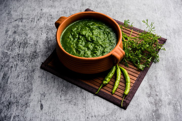 Kothimbir or Dhaniya Chutney made using Cilantro or coriander with chilli, served in a bowl. selective focus