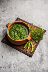 Kothimbir or Dhaniya Chutney made using Cilantro or coriander with chilli, served in a bowl. selective focus