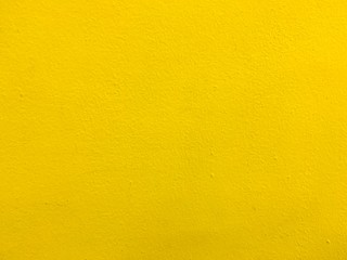 Yellow plastered cracked wall