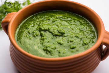 Kothimbir or Dhaniya Chutney made using Cilantro or coriander with chilli, served in a bowl. selective focus