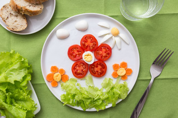 Funny food for kids. Flowers made of vegetables and eggs. Idea for baby spring lunch
