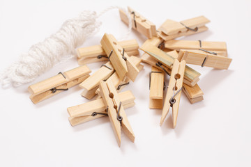 Set of wooden clothes pins on white background