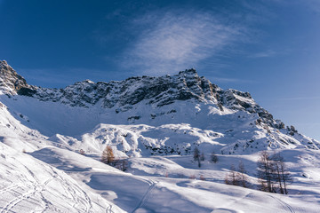 The mountains of the Aosta Valley during the dawn of a winter day near the Matterhorn and the village of Valtournenche, Italy - December 2019.