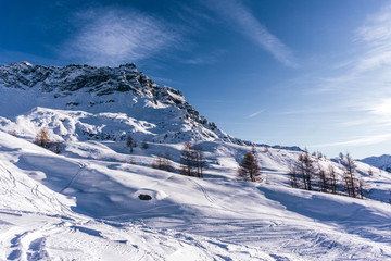 The mountains of the Aosta Valley during a fantastic winter day near the Matterhorn and the town of Breuil-Cervinia, Italy - December 2019.