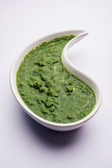 Kothimbir or Dhaniya Chutney made using Cilantro or coriander with chilli, served in a bowl. selective focus