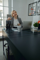 Happy pretty woman having fun while make video for vlog