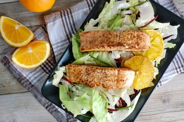 Fresh salad with lettuce, beetroot, orange and salmon fillet