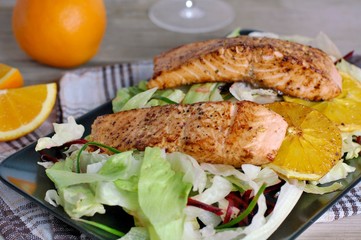 Fresh salad with lettuce, beetroot, orange and salmon fillet