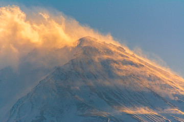 Fuji mountain peak, sunlight shining clouds.