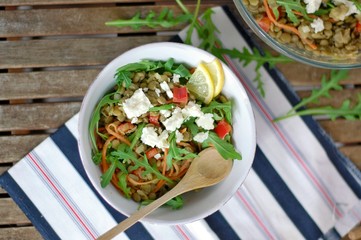Lentil salad with arugula, pepper, carrot, lemon and cheese