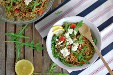 Lentil salad with arugula, pepper, carrot, lemon and cheese