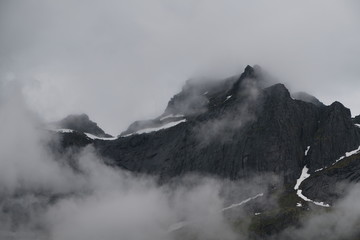 nusfjord, lofoten islands, norway, unesco, famous unesco village, traditional fishermen cottages, mountains, moody weather, fog, foggy, seeweed,red cabins, tourists place, muset see, hidden gem