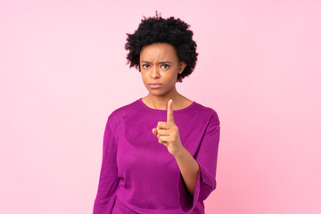 African american woman over isolated pink background frustrated and pointing to the front