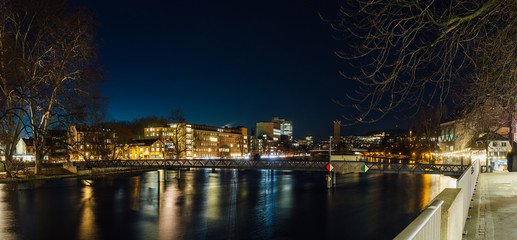 Wide angle long exposure of the Limmat river in Zurich city center at night.