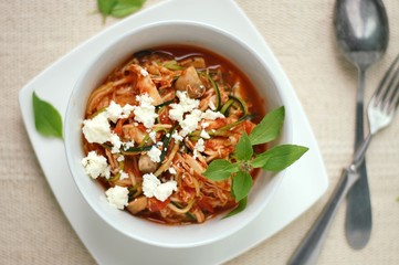 Zucchini spaghetti in sauce with tomato, basil, meat and cheese